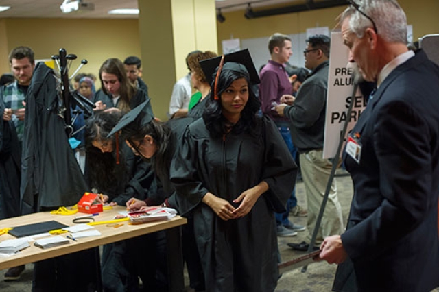 Students dressed in graduation gowns.