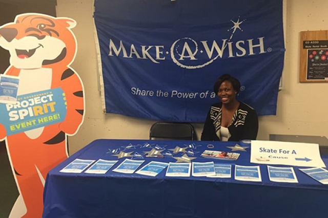 Person posing at table for "Make a Wish"