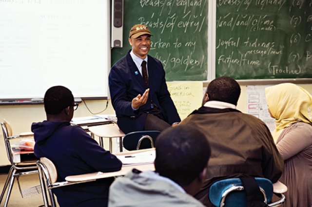 Person posing in front of classroom