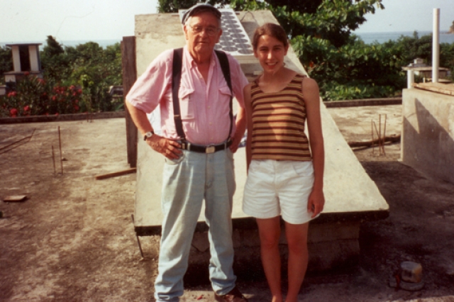 Two people posing for camera on top of building