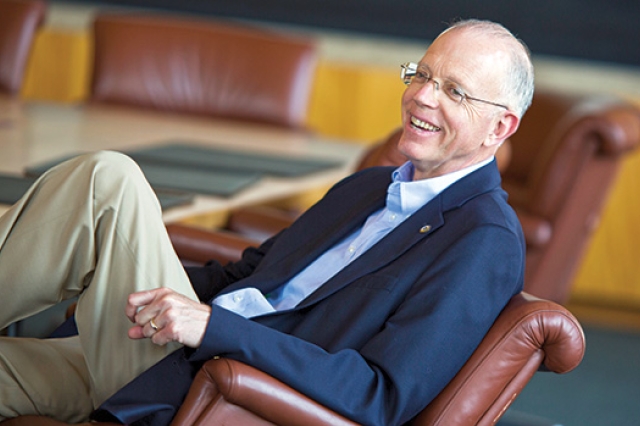 Professor posing for camera in chair