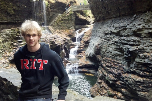 Person posing in front of waterfalls