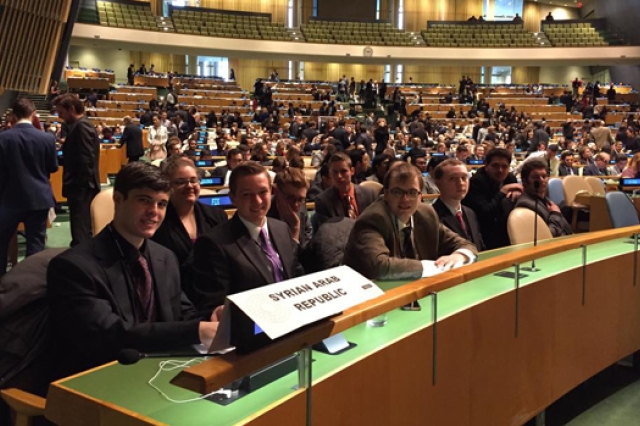 People gathered at long table for conference