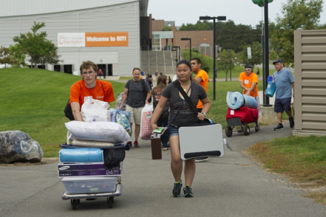 People walking down path with bags