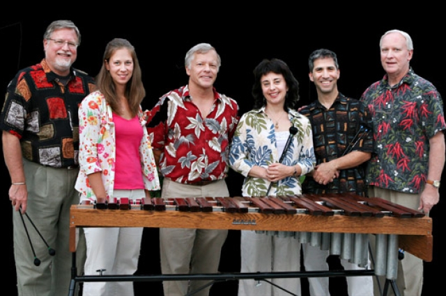 People posing behind xylophone