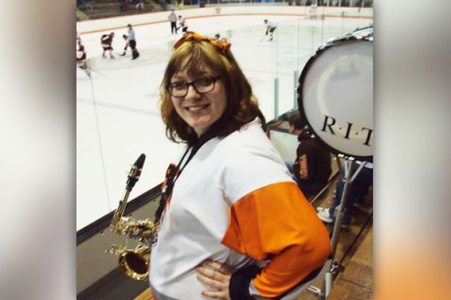 Person posing with saxophone