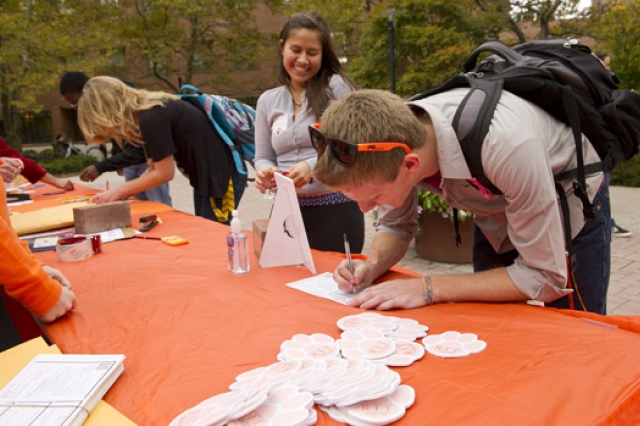 People signing documents at table