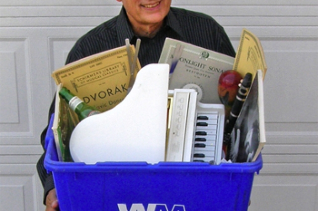 Person holding recycling bin