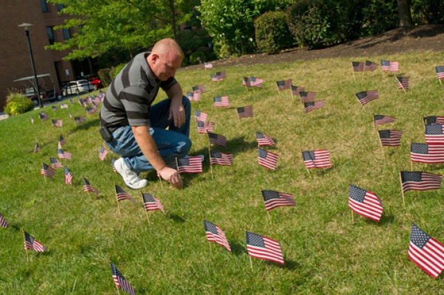 Person laying down flags on gas patch