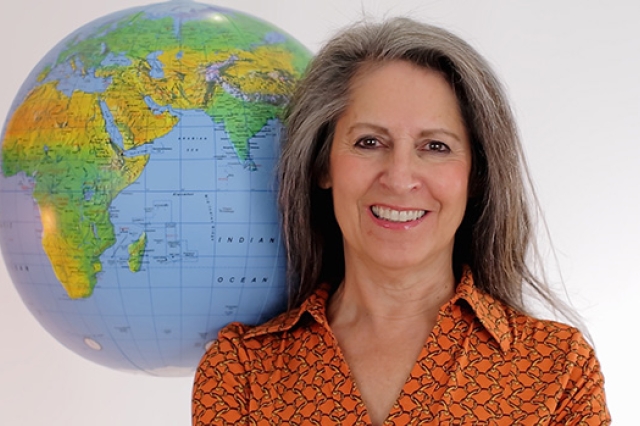 CEO posing next to globe