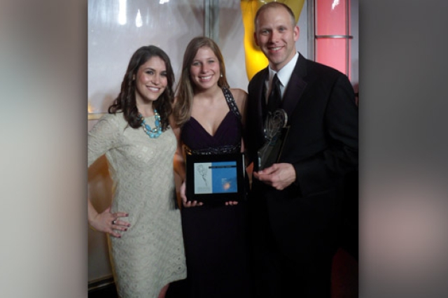 People posing with award