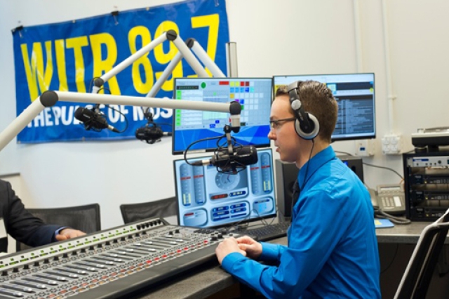 Person speaking into radio