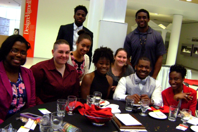 People posing around table 