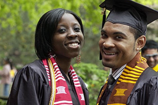 Two RIT graduates posing 