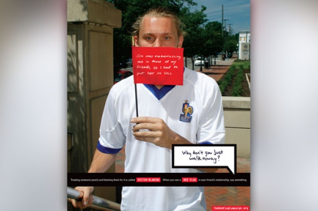 Person posing for camera with flag infront of mouth