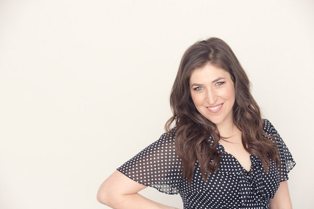 A portrait of Mayim Bialik in a polk-a-dot dress.