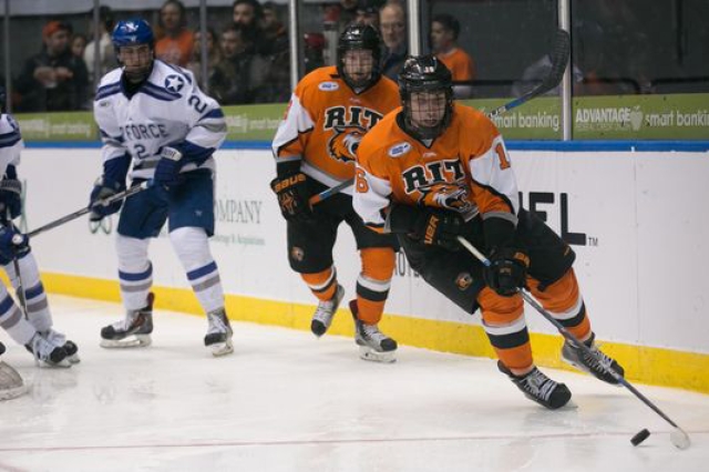 RIT and Air Force hockey players chase the puck