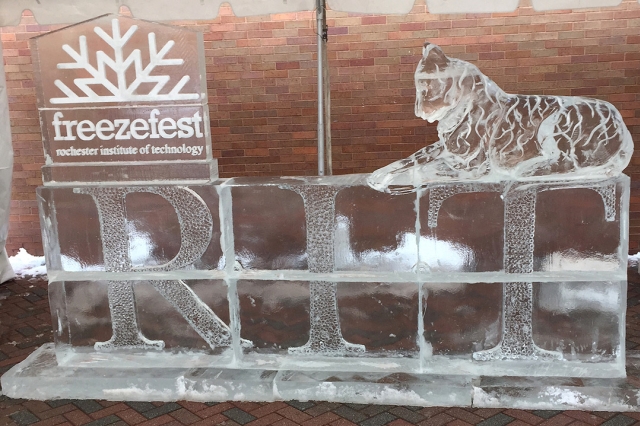 Ice sculpture of the word RIT with a tiger sitting on top