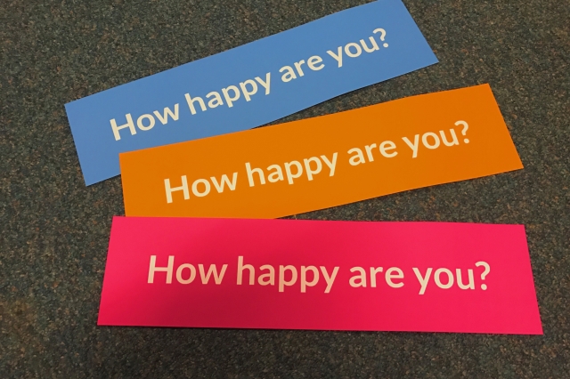 3 signs of different colors with the text "How happy are you?"