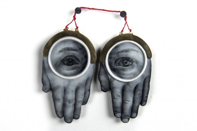 A sculpture of two hands with eyes on them.