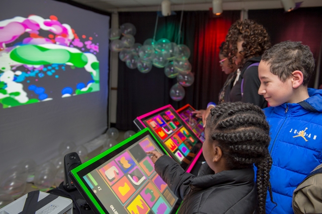 Students use colorful touchscreens.