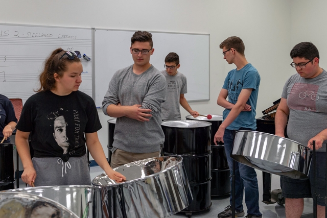 Students play steel drums.
