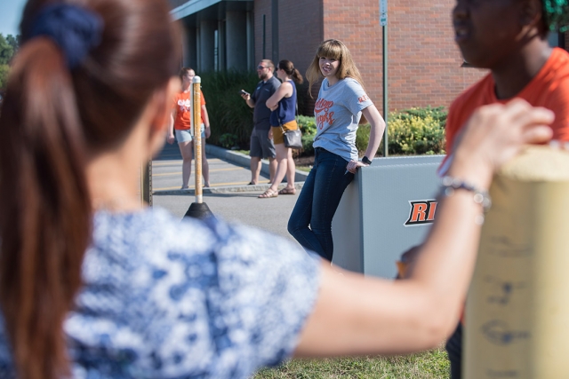 Students help new students move in.