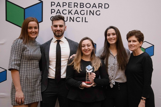 Group of five students and professor pose with glass award.