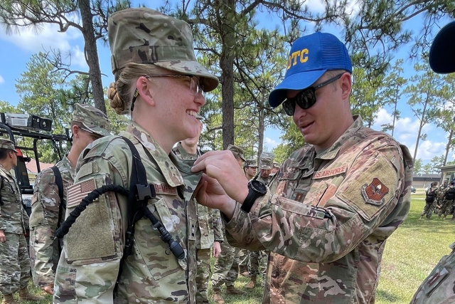 ROTC cadet receiving insignia for the Professional Officer Course.