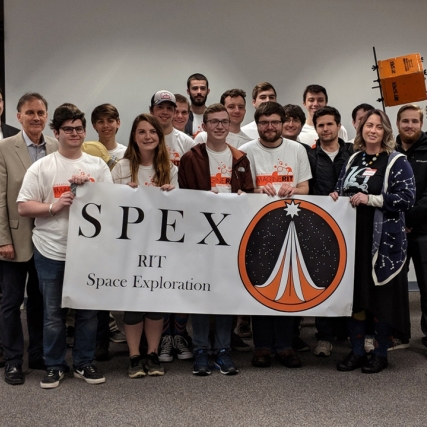 group of students holding a banner that reads: SPEX RIT space exploration.