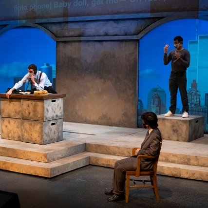 three actors performing on stage.