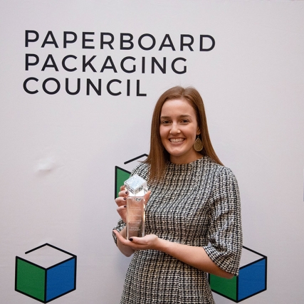 stuent posing with glass award.