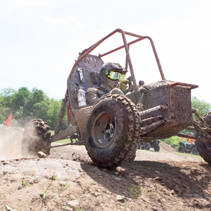 baja off-road vehicle cresting a hill.