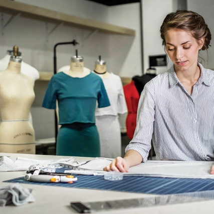 student working on a dress pattern.