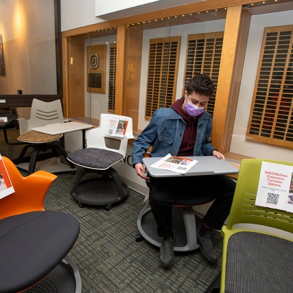 student trying out new chairs for a clasroom.