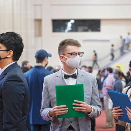 students waiting in line at a career fair.
