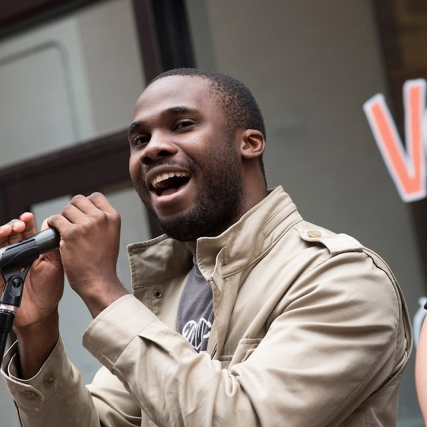 student singing into a microphone.