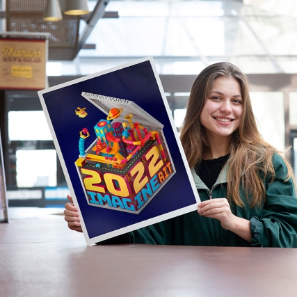 student holding a poster that reads 2022 Imagine RIT.