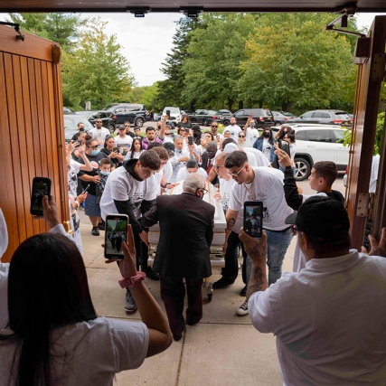 people bringing a casket into a chapel.