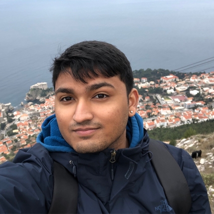 student standing on a mountain overlooking the city of Dubrovnik.