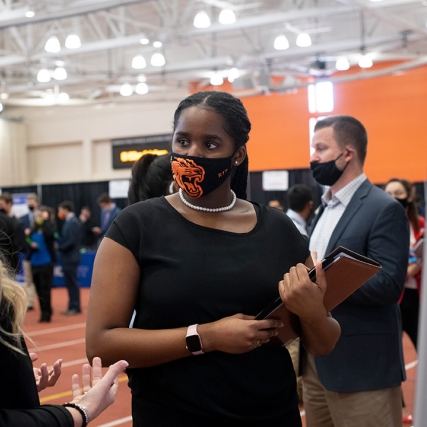 student and employer meeting at a career fair.