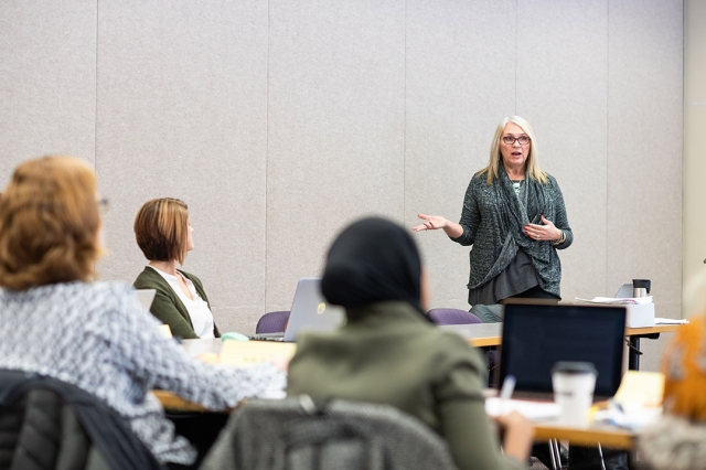 professor talking to a room of people.