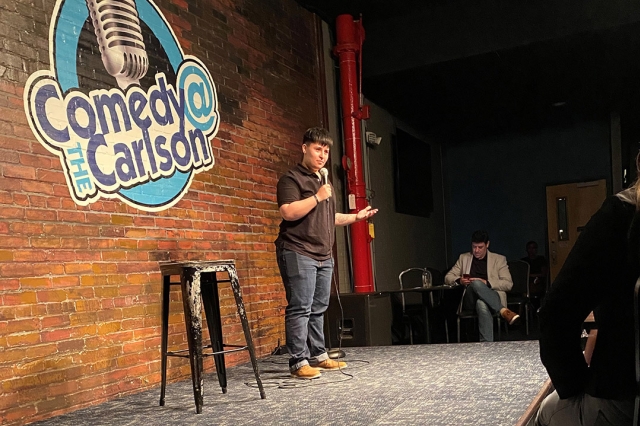 comedian performing on stage.