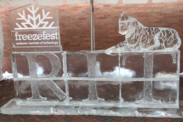 ice sculpture with a tiger and the RIT logo and freeze fest snowflake logo.