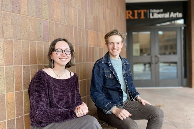 Emma Nastro, left, and Lee Sortore, right, sitting on a bench outside of Liberal Arts Hall.
