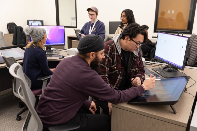 Graduate students collaborate in a lab. 