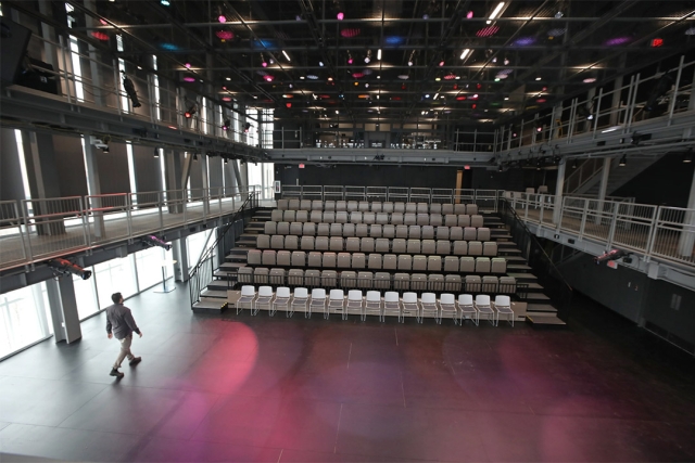 stadium style seating in an empty theater space.