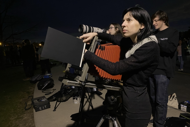 Student Kristy Sorochan operates an 11x14 large format camera during the eclipse.