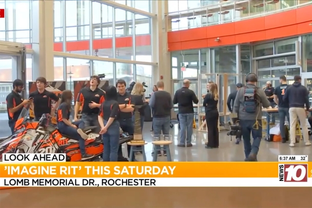 Students are shown gathering around a snowmobile, which is one of the exhibits at Imagine RIT.