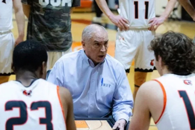 Bob McVean appears between two players holding a laptop that shows an upcoming play.